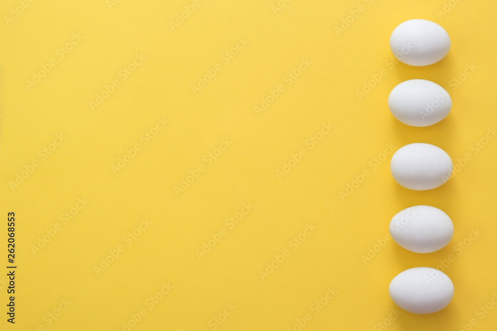 Easter eggs in a row on a yellow background. Easter holiday creative greeting card. Flat lay. Copy space. Top view Easter eggs in a row on a yellow background. Easter holiday creative greeting card. Flat lay. Copy space. Top view