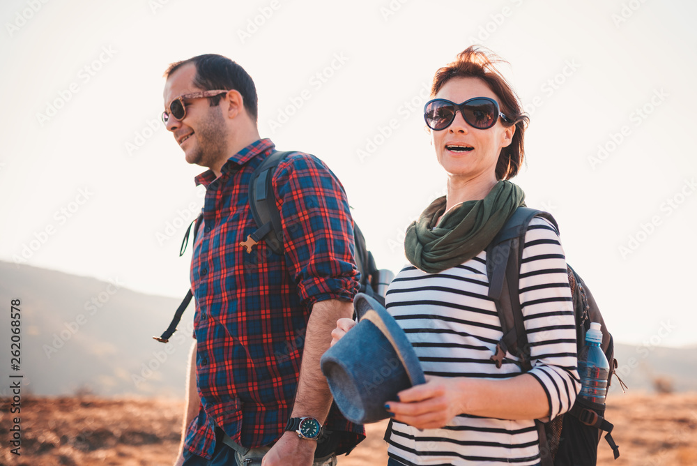 Happy couple hiking together on a mountain