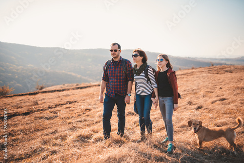 Family with dog hiking on a mountain