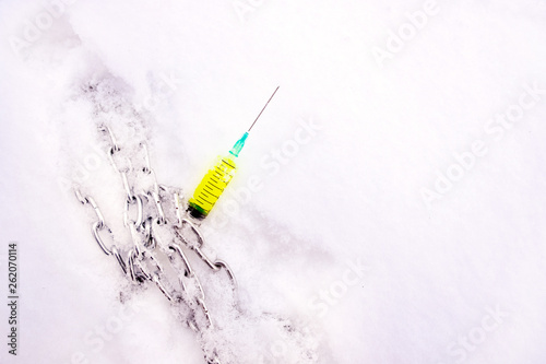 the chain is thrown on a syringe with a yellow bright toxic liquid