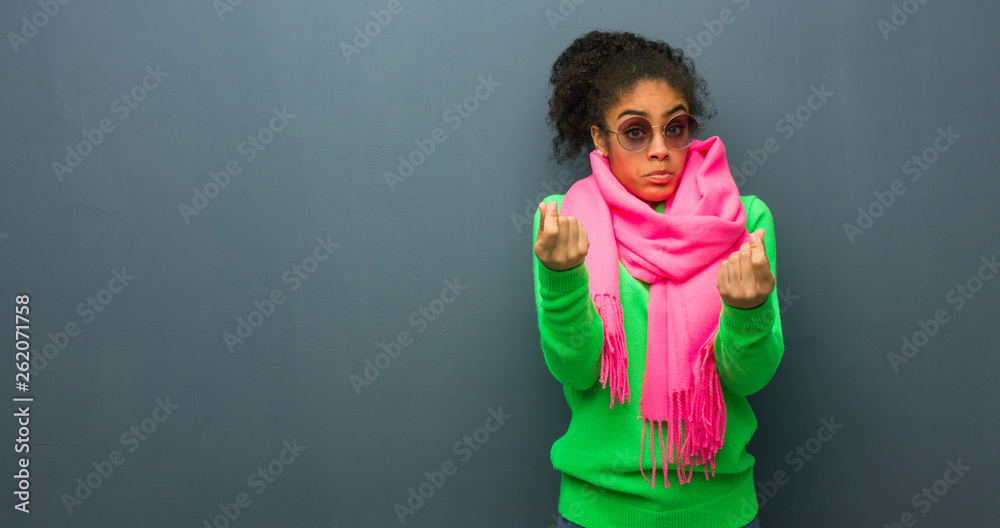 Young african american girl with blue eyes doing a gesture of need Young african american girl with blue eyes doing a gesture of need