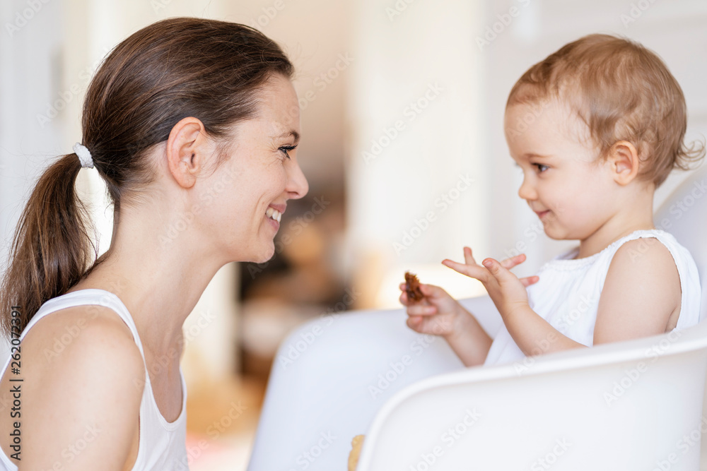 Profile of happy mother watching her little daughter Profile of happy mother watching her little daughter