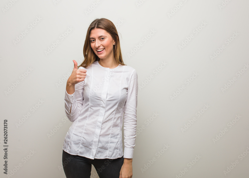 Young russian girl smiling and raising thumb up Young russian girl smiling and raising thumb up
