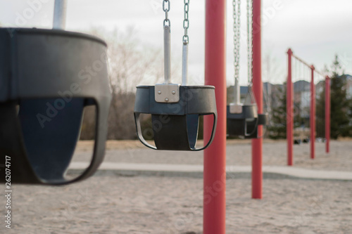 Baby Swings on a swing set in a public park, swinging