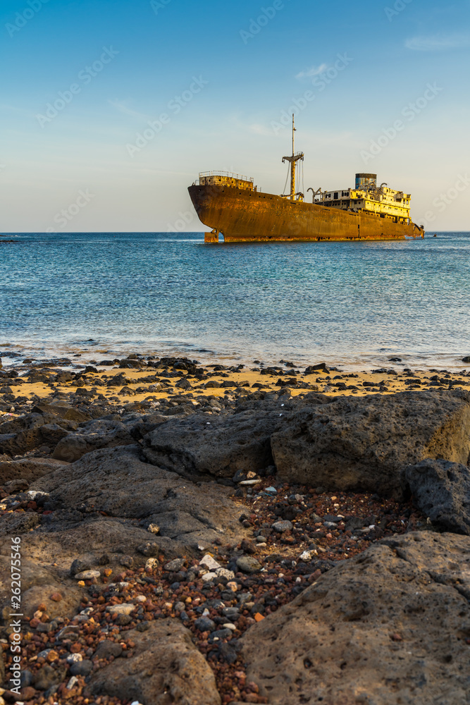 Spain, Lanzarote, Rusty wreck of stranded temple hall freightliner ship at small bay of arrecife