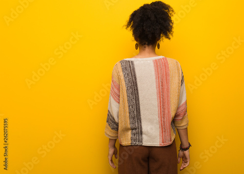 Young black african american girl with blue eyes from behind, looking back
