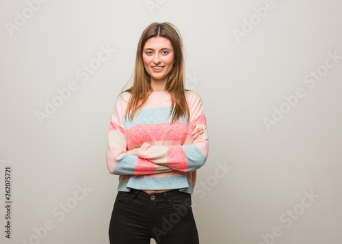 Young russian girl crossing arms, smiling and relaxed