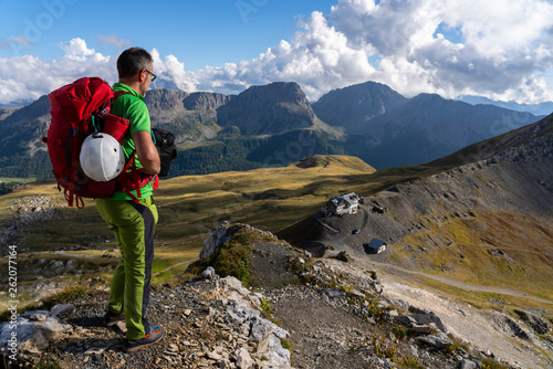 Italy, Veneto, Dolomites, San Pellegrino Pass, mountaineer standing near Paradiso mountain hut photo