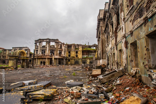 Fototapeta Naklejka Na Ścianę i Meble -  The city ruins after the war. Ruins of war. Broken city after the military bombing. The bombed-out buildings. The wreckage of buildings. War destruction.