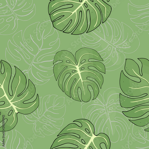 Seamless pattern with tropical monstera leaves on on green background.
