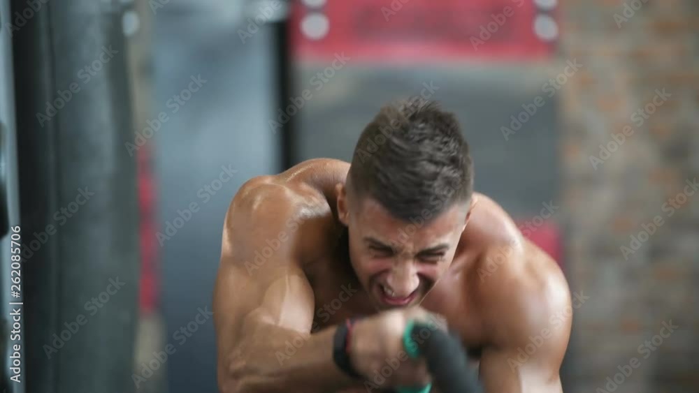 fitness athletes training using battle ropes intense workout team exercise challenge in gym enjoying healthy bodybuilding endurance practice lifestyle together 