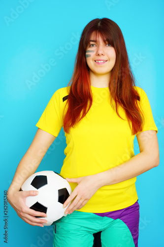 Woman is socccer fan in yellow t-shirt with soccer ball © nuclear_lily