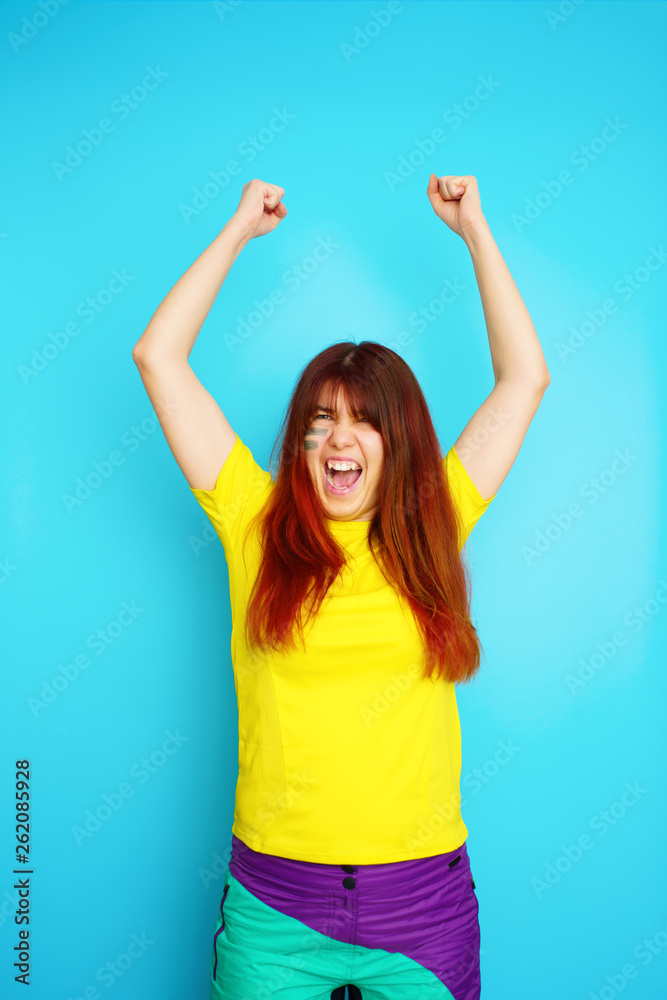 Woman is socccer fan in yellow t-shirt