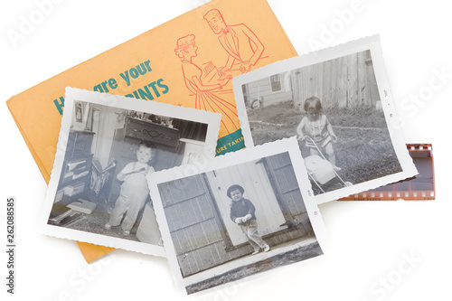 Three black and white snapshots with a photo envelope and piece of negative all vintage