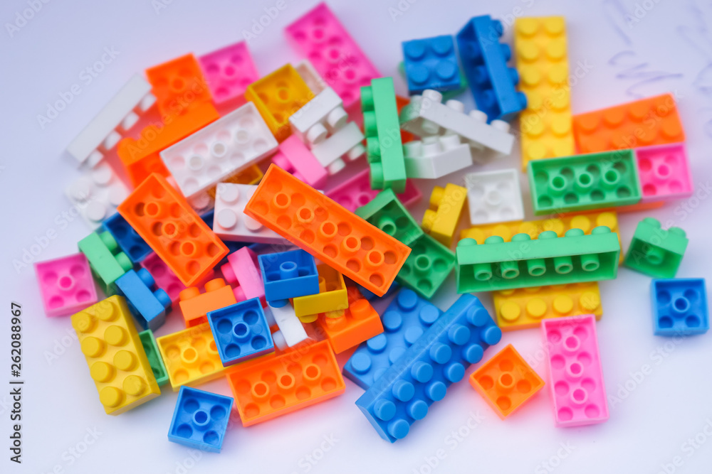 Multicoloured plastic construction blocks or bricks toy on white background Multicoloured plastic construction blocks or bricks toy on white background
