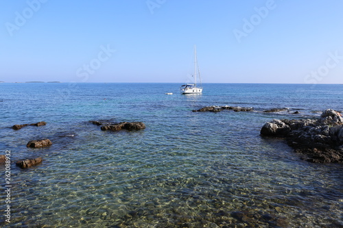 Single Yacht in the Adriatic Sea, rocks and clear water