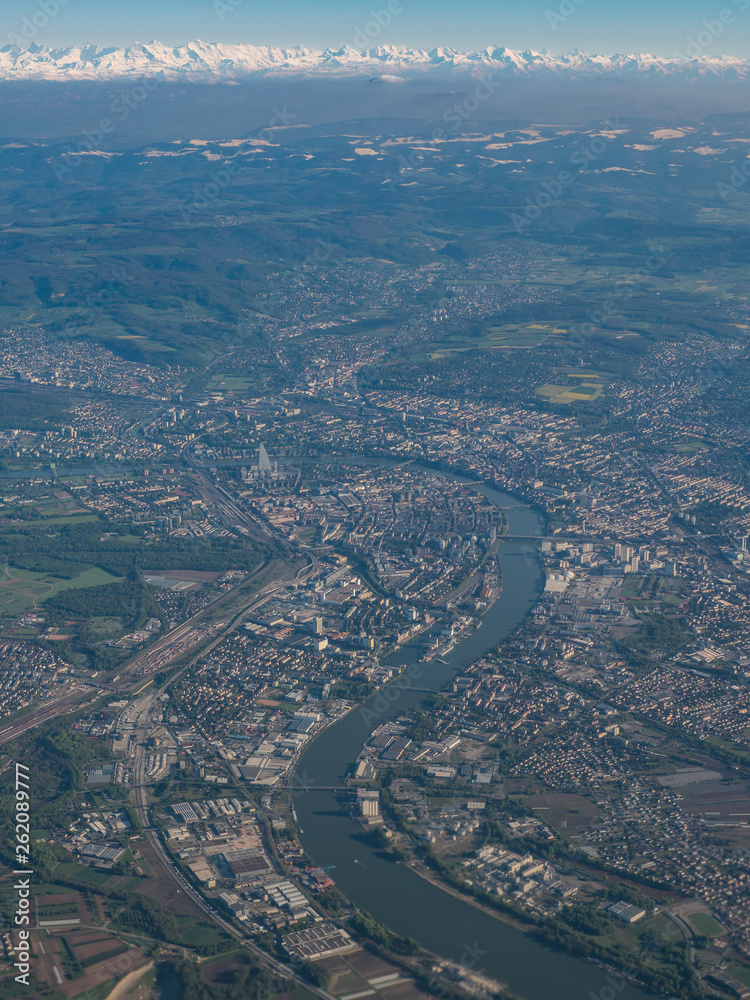 Rhine river, Basel city, Jura and Alps mountains on horizon in one frame from bird's view