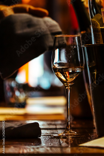 a Glass of wine on the wooden table of the restaurant.