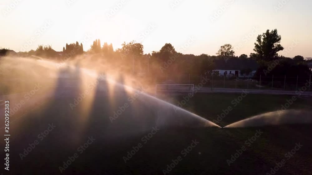 Aerial view of watering the lawn of a football field Aerial view of watering the lawn of a football field
