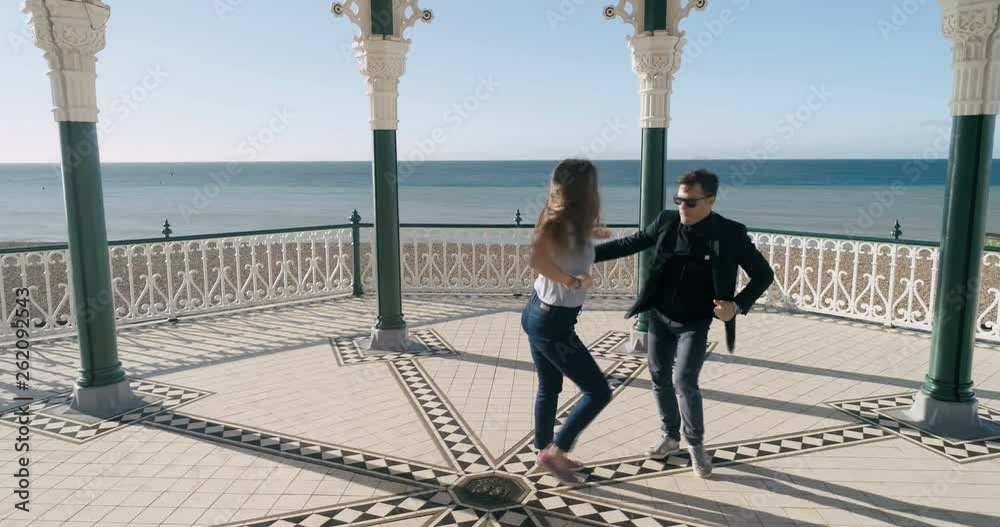 Aerial view of Caucasian young couple dancing salsa in the Victorian bandstand in Brighton