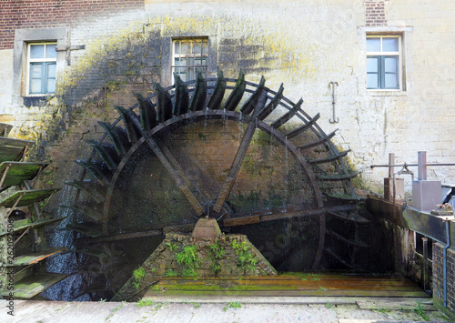 Waterwheel of a authentic watermill that uses hydropower. photo