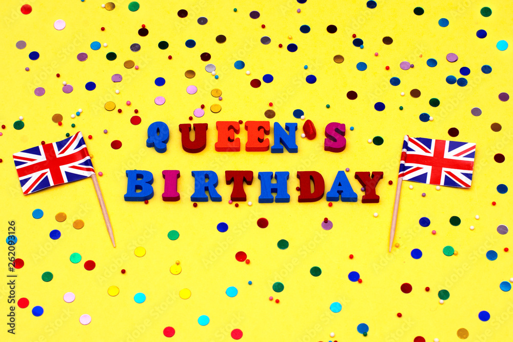 text - birthday of the Queen in bright letters, decorated with colored stones on a yellow background