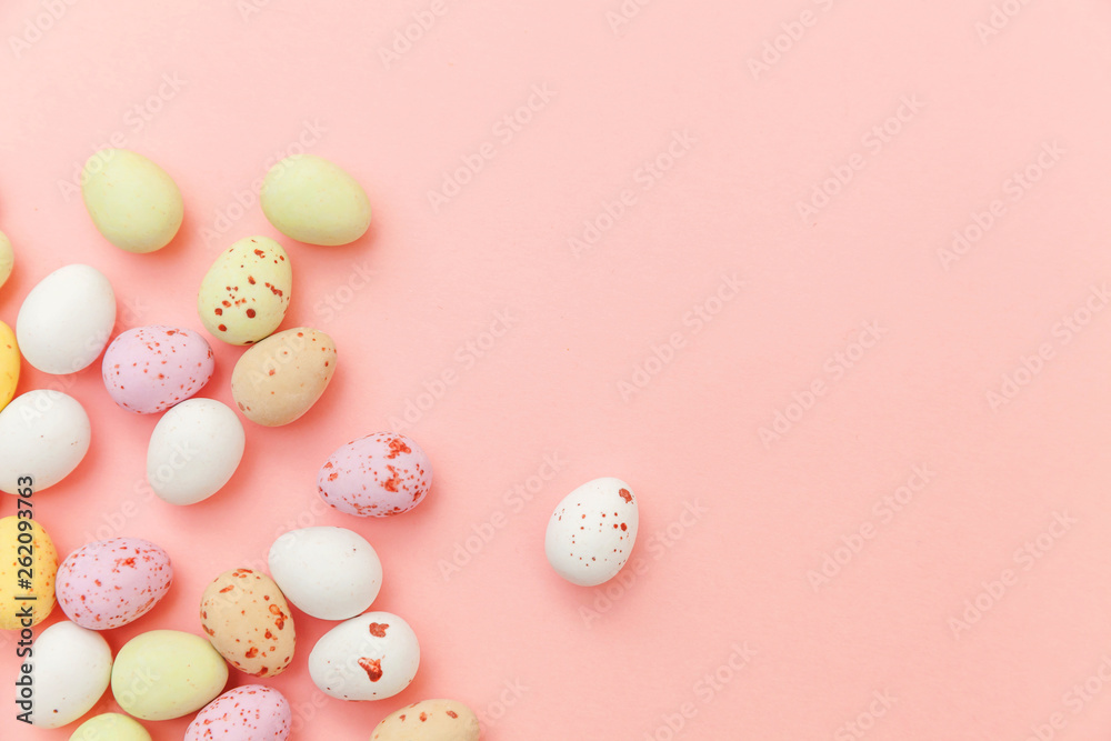 Happy Easter concept. Preparation for holiday. Easter candy chocolate eggs and jellybean sweets isolated on trendy pastel pink background. Simple minimalism flat lay top view copy space Happy Easter concept. Preparation for holiday. Easter candy chocolate eggs and jellybean sweets isolated on trendy pastel pink background. Simple minimalism flat lay top view copy space