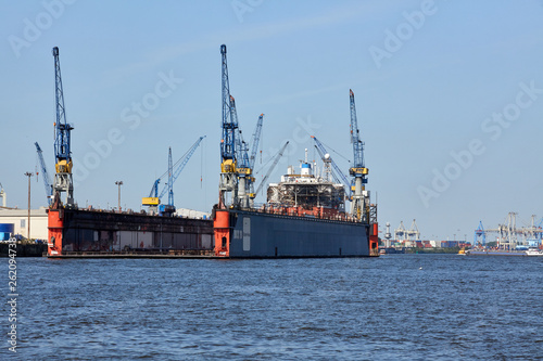 Cranes of Port of Hamburg on Elbe river, Germany. The largest port in Germany and one of the busiest and largest ports in Europe