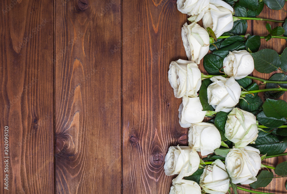 White roses on wooden background White roses on wooden background