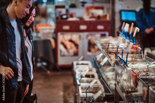 Photography Asian couple looking for something special at market.