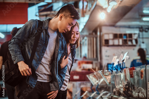 Photography Asian couple looking for something special at market.
