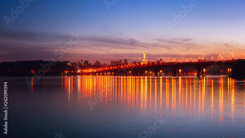 Panoramic view of the Paton bridge, Motherland monument and Dnieper river at night, beautiful cityscape with city lights, Kiev the capital of Ukraine