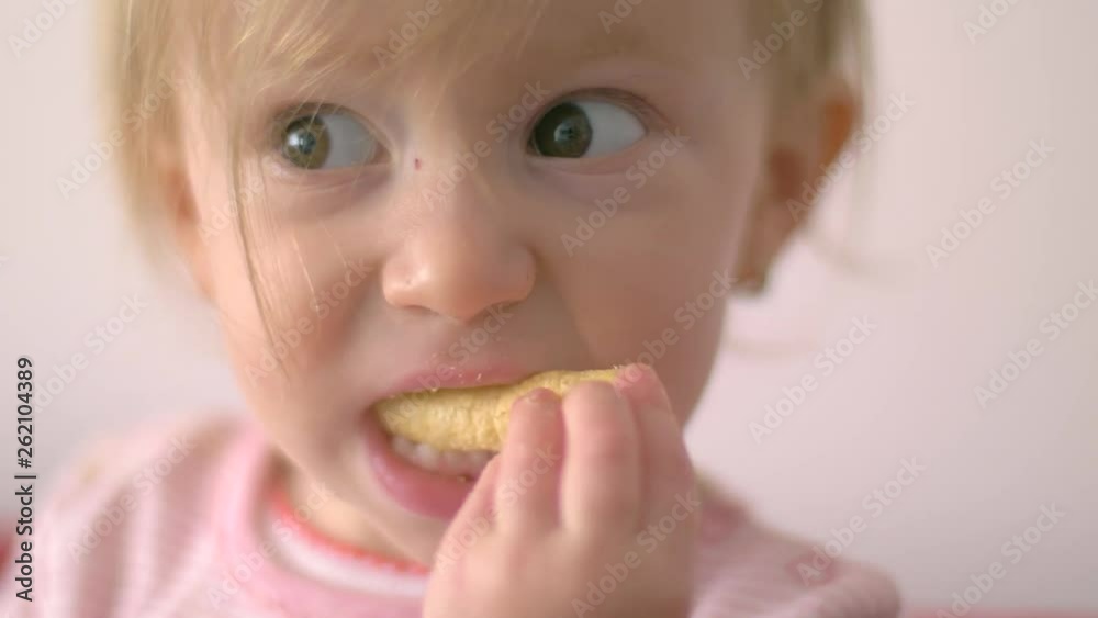 Cute girl eating Corn Sticks. Slow motion Cute girl eating Corn Sticks. Slow motion