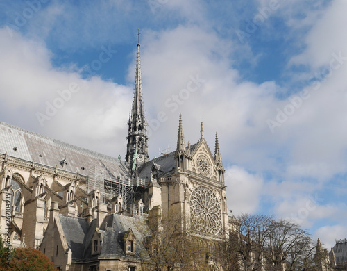 Notre Dame de Paris. the view from the river. visible tower with a spire. no people. horizontal photo. day. scaffolding. repair