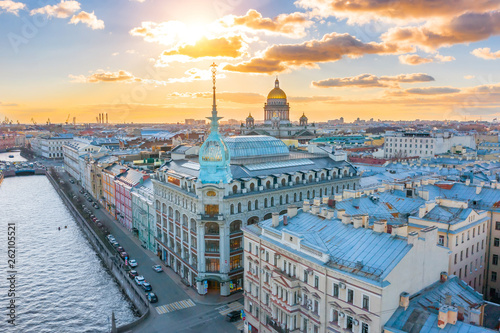 Department store shop class luxury, near the Red Bridge, historical buildings of Saint-Petersburg. In the background the city and St. Isaac's Cathedral dome of golden color, in the evening at sunset. photo