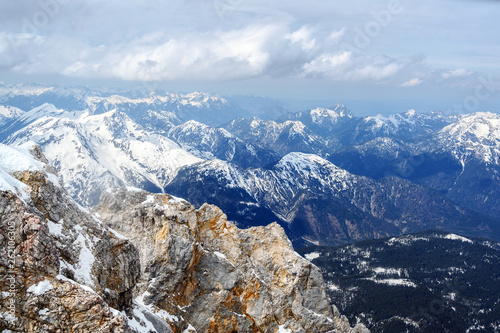 rugged cliffs and snow-capped mountains in the bavarian alps in germany, view from the zugspitze towards austria photo