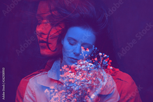 Art portrait of a young pretty woman. Color double exposure.