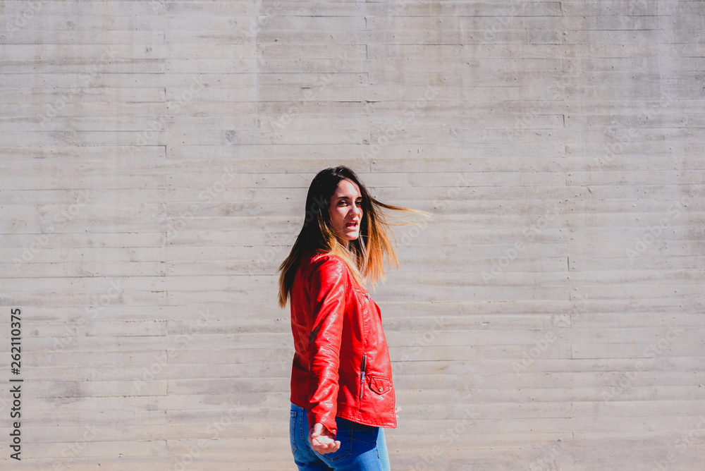 Woman with jeans in the center of the image turning surprised, gray smooth background and copy space. Woman with jeans in the center of the image turning surprised, gray smooth background and copy space.