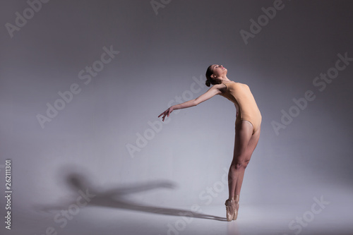 Fototapeta Naklejka Na Ścianę i Meble -  young beautiful ballet dancer in beige swimsuit