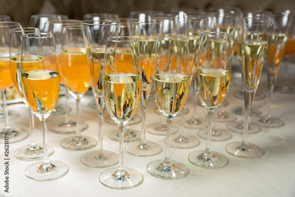 many glasses of champagne are on the table. Horizontal frame many glasses of champagne are on the table. Horizontal frame