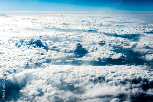 Top view of white clouds above the ground or water