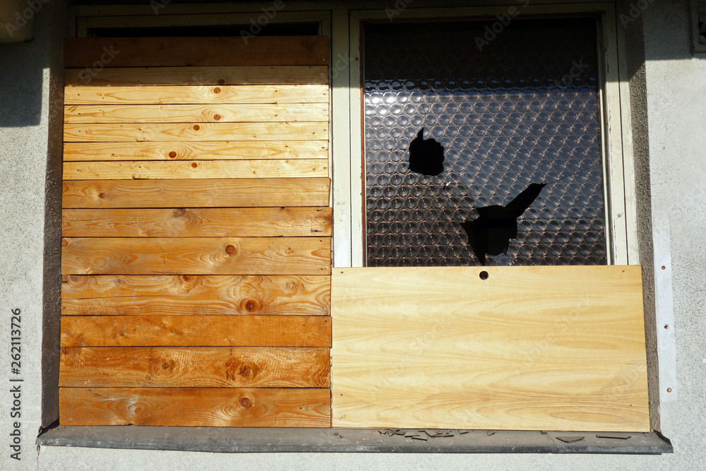 Barred window with wooden boards Stock Photo | Adobe Stock