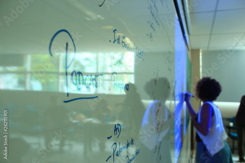 Woman writing in whiteboard