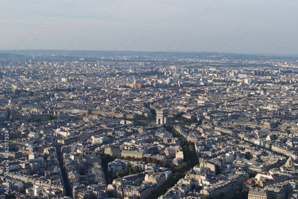 Obraz premium Cityscape - Paris (France) seen from above on a sunny day. Arc de Triomphe visible.