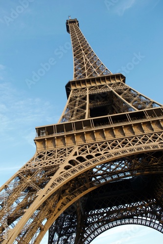 Looking up at Eiffel Tower against blue sky © Robert