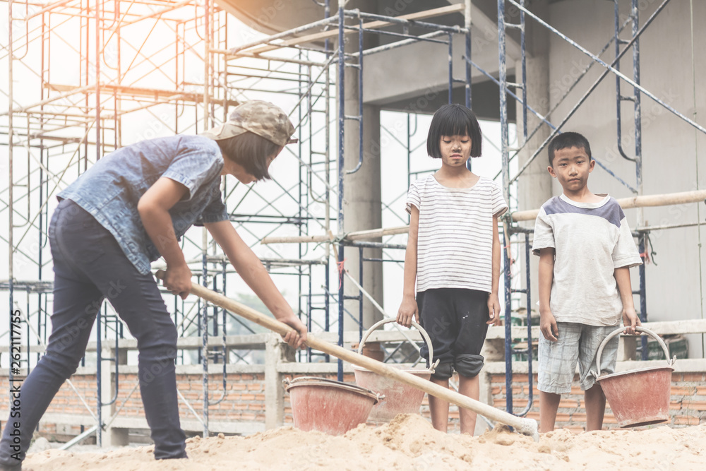 Children working at construction site for world day against child labour concept: