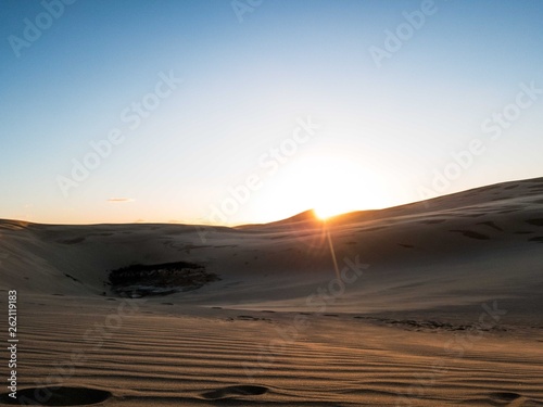 Sunset behind Giant Sand Dunes near Cape Rienga  New Zealand