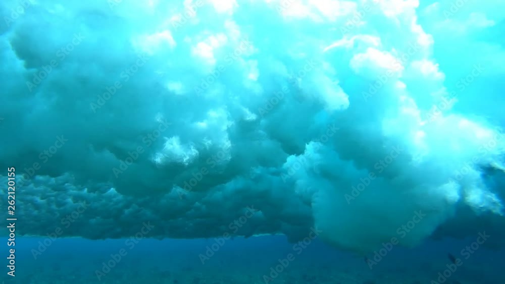 Underwater view of the crystal clear wave breaking over the reef Underwater view of the crystal clear wave breaking over the reef