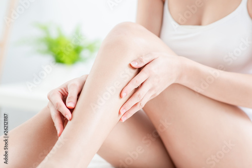 woman touching perfect shaved legs photo