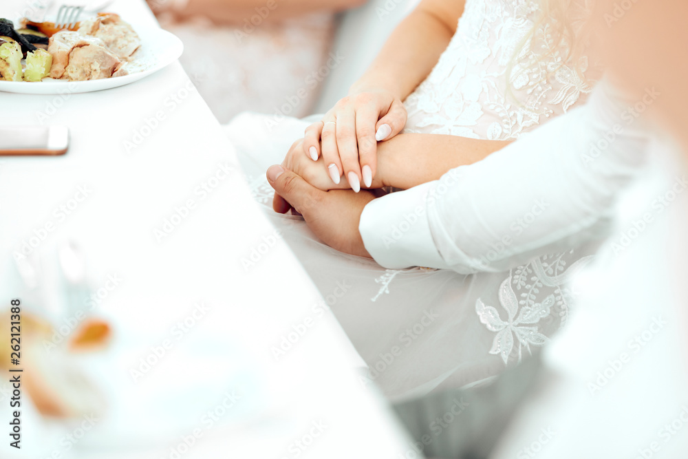 boy and girl dressed in white hold each other's hands boy and girl dressed in white hold each other's hands